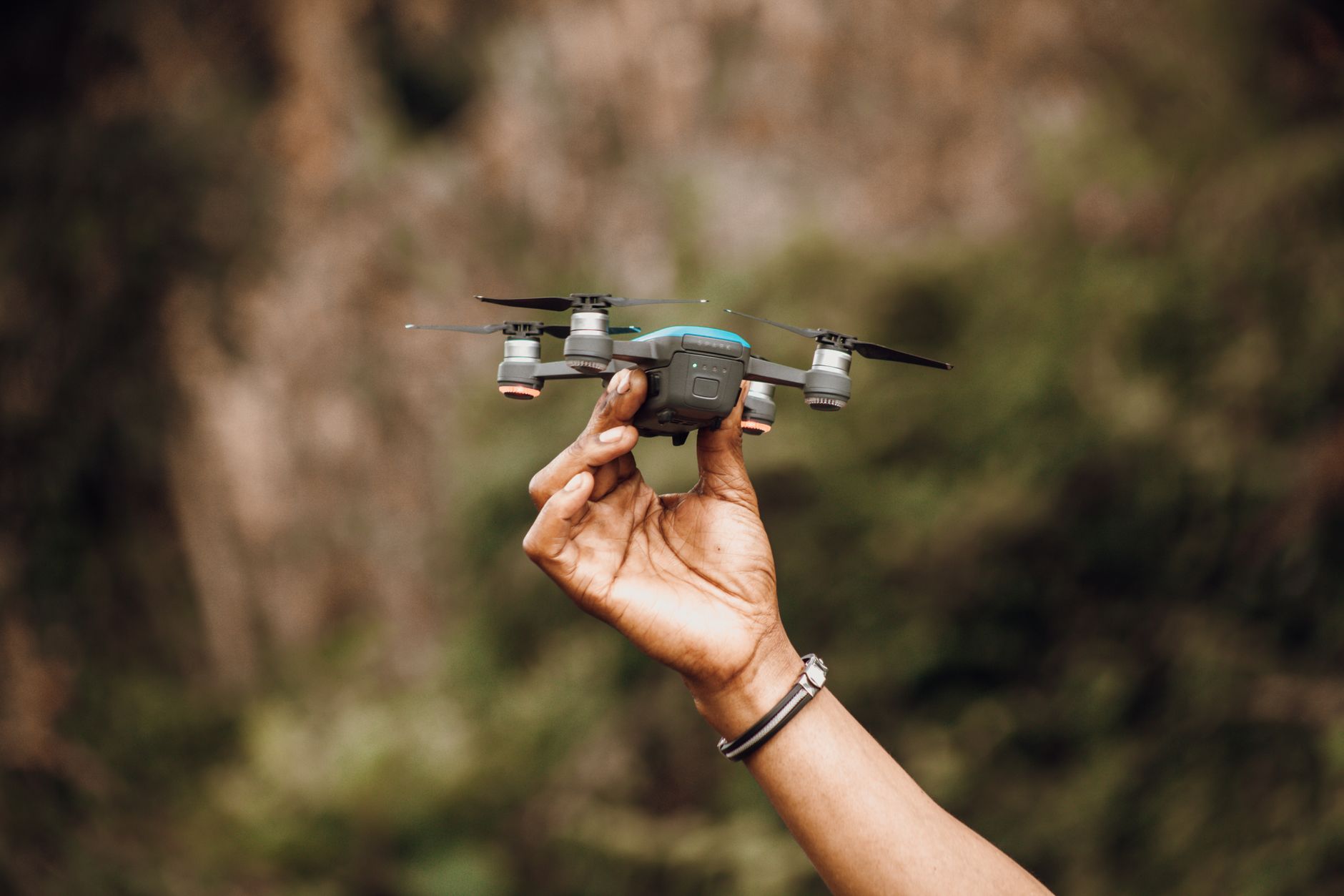 Small drone flying outdoors against a bright sky