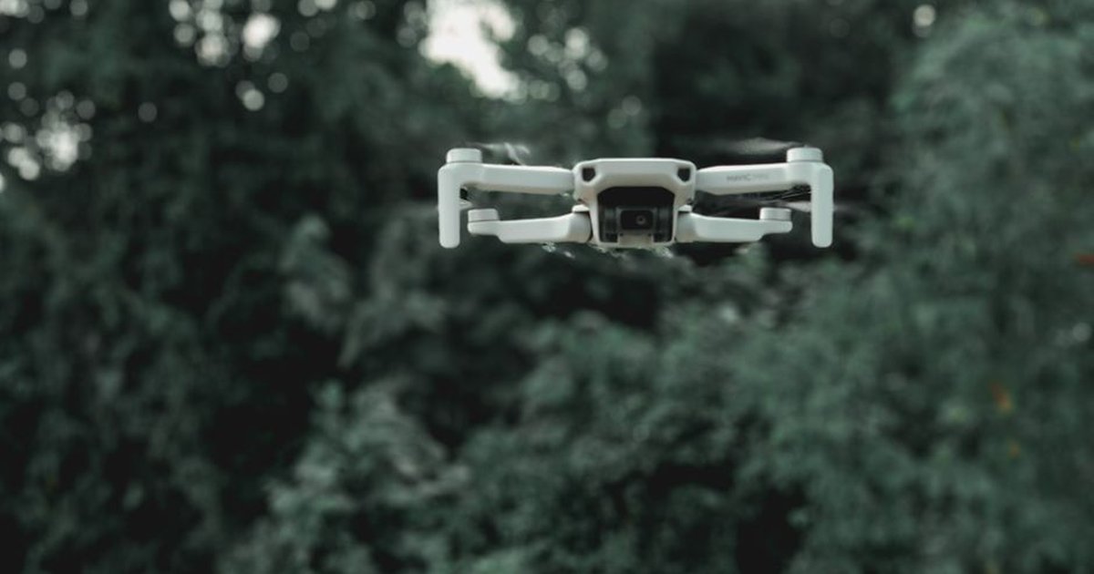 Toy drone in mid-flight inside a living room