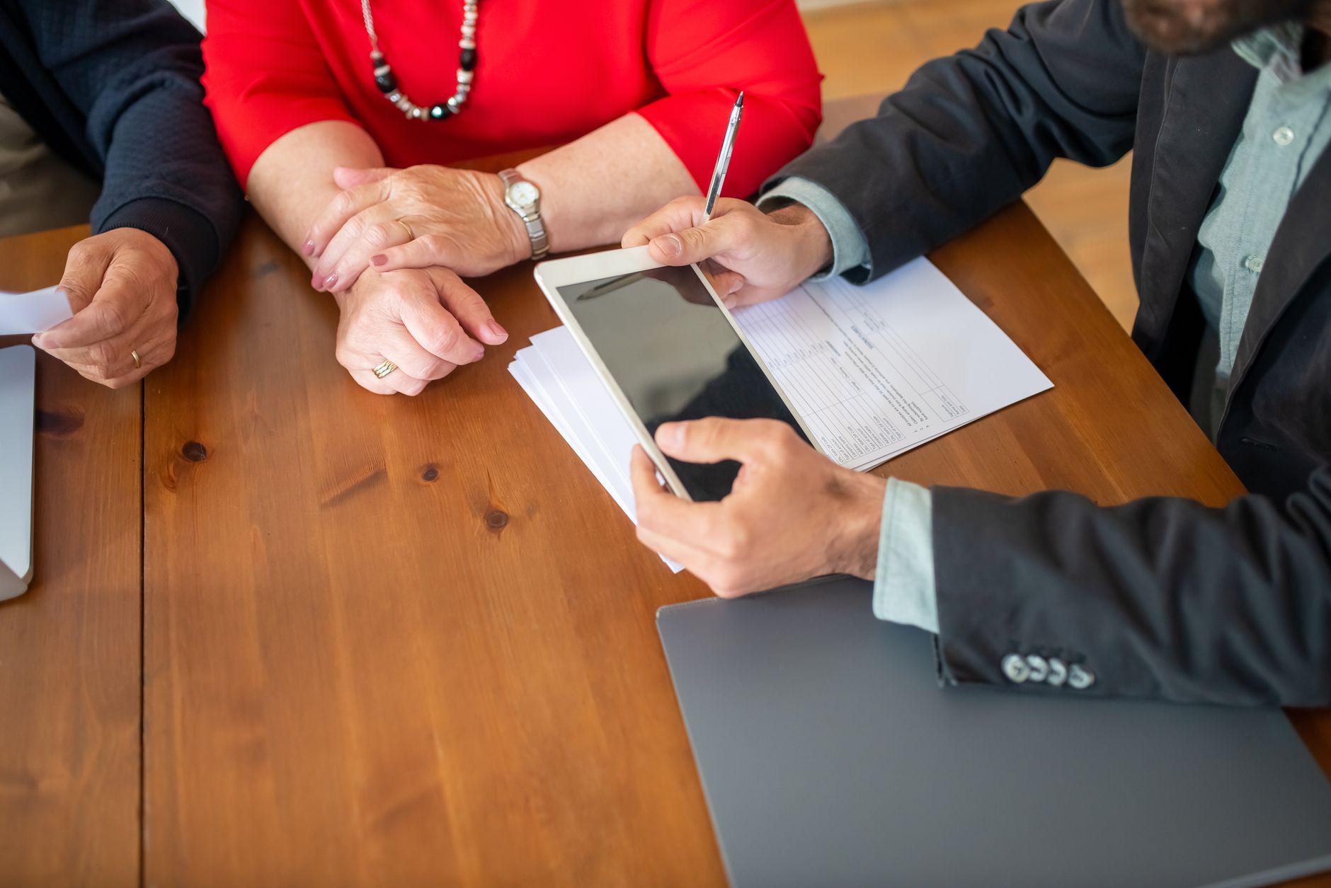 Drone remote controller next to printed insurance documents on a desk