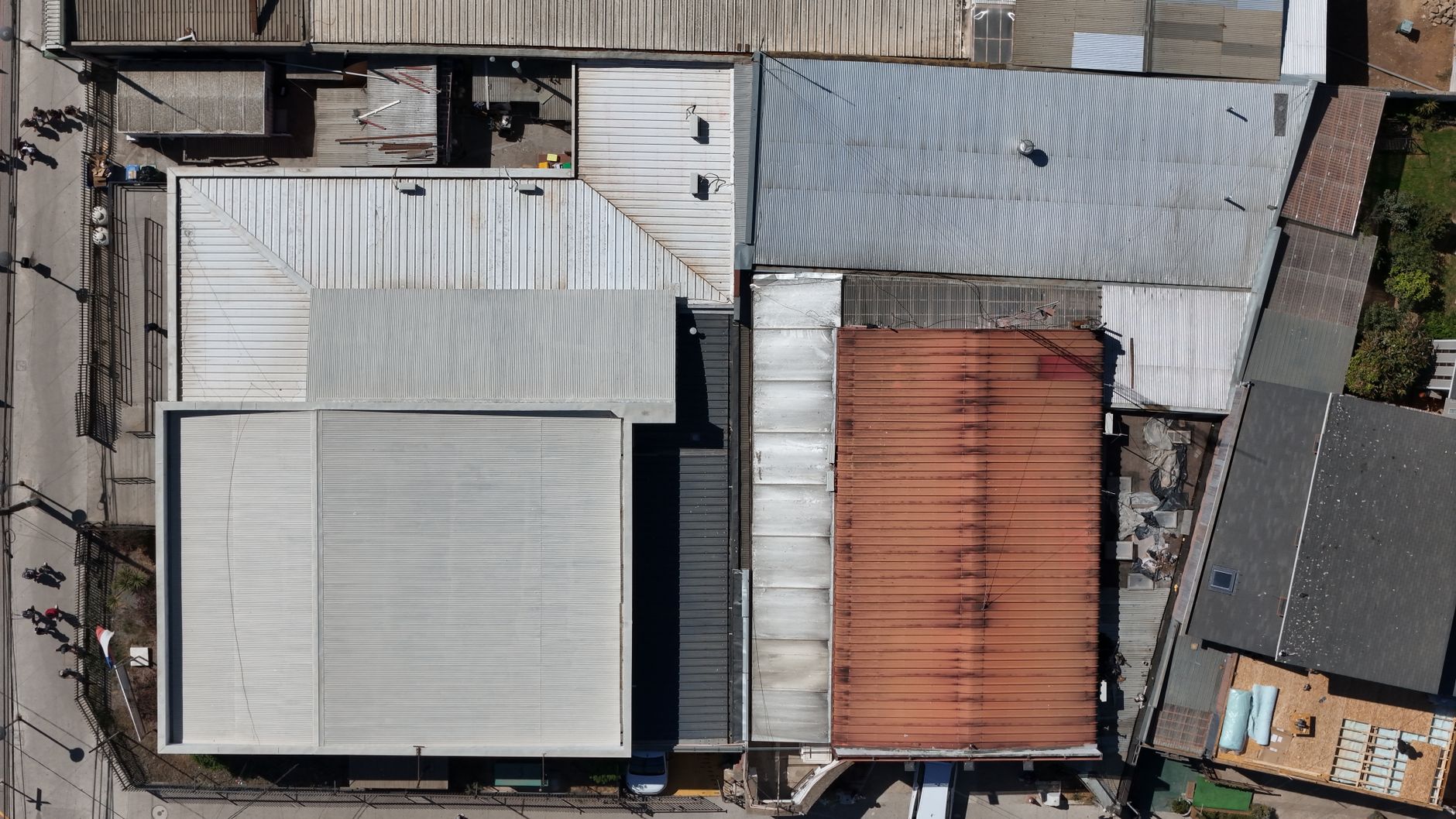 Drone inspecting a commercial building roof for thermal survey work